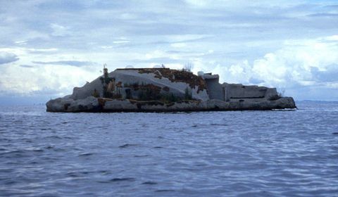 A concrete island floats across an expanse of water.
